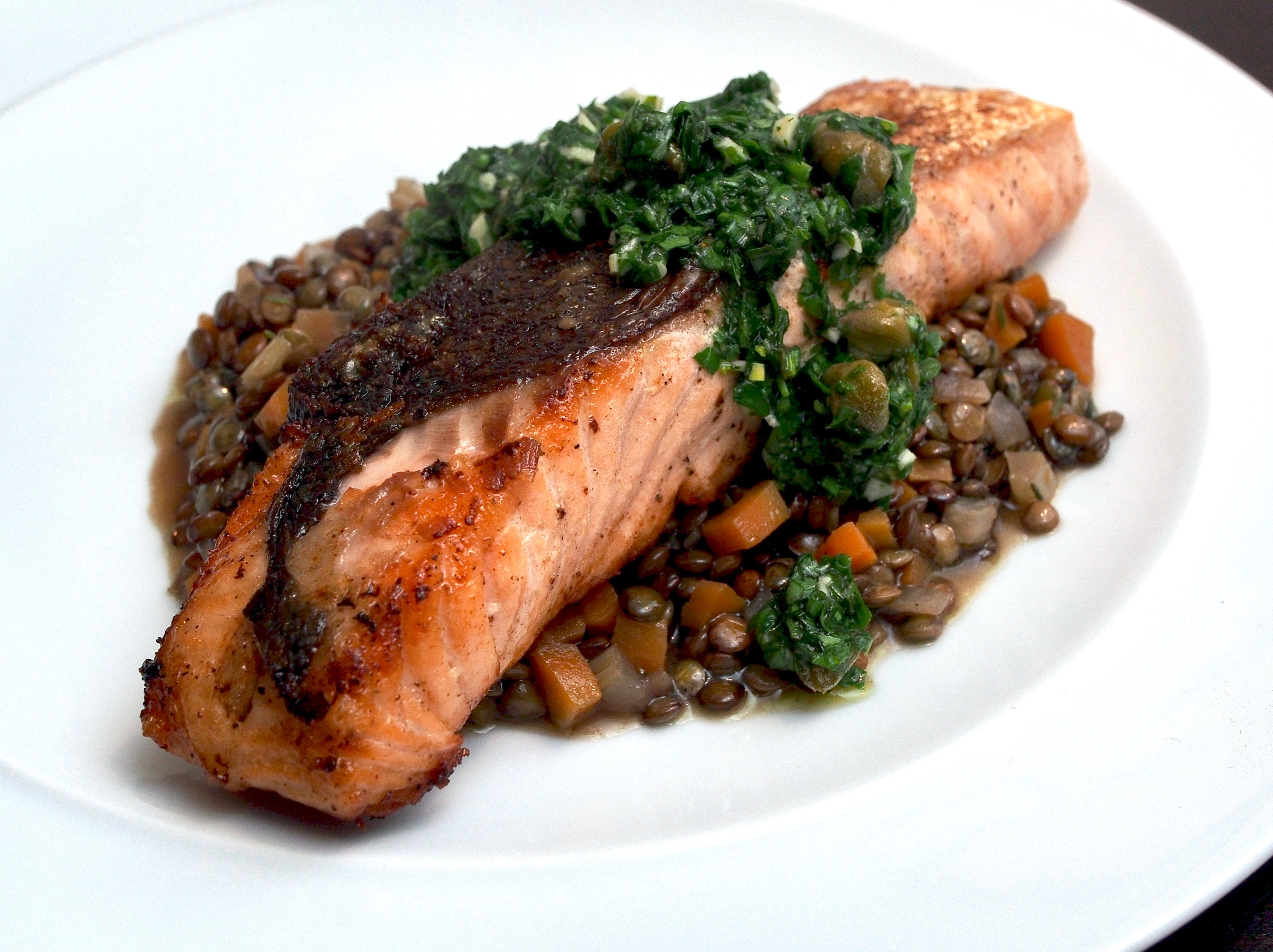 Salmon on lentils with herb relish
