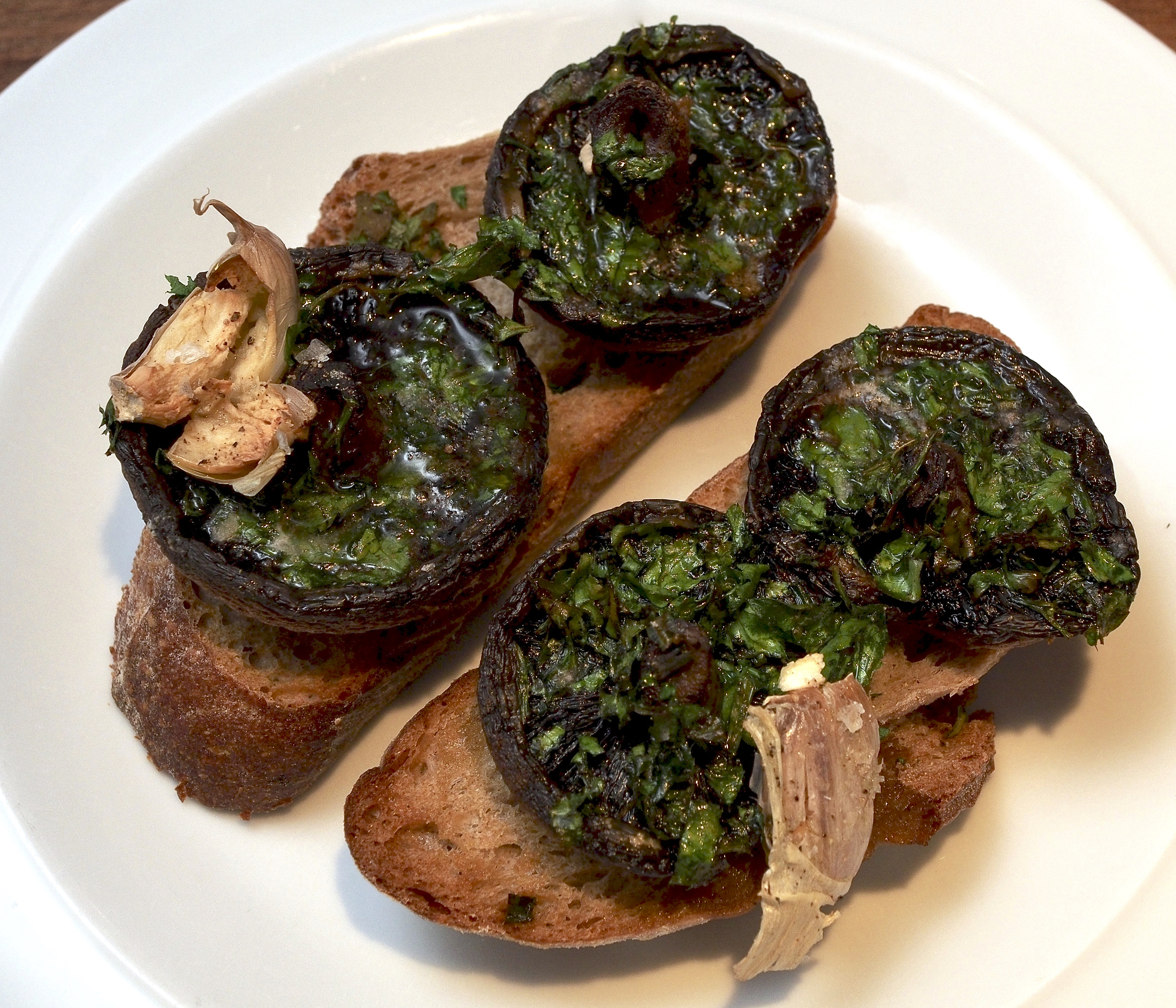 Mushrooms baked on toast with herbs, butter & garlic